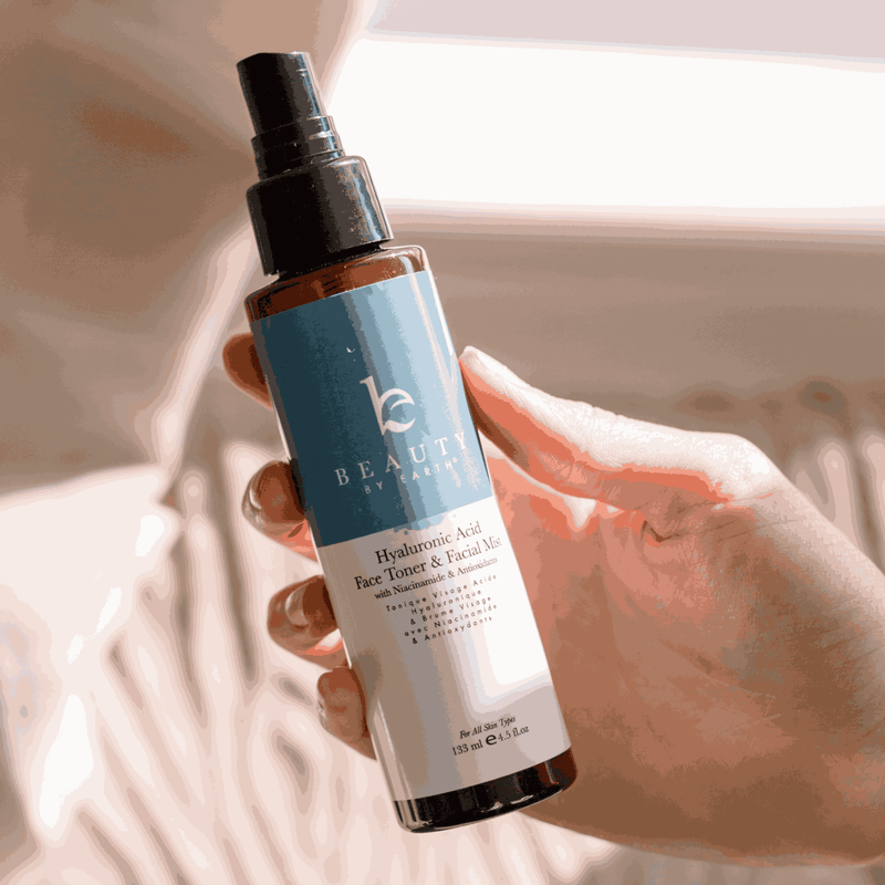 Hand holding a bottle of skincare product with a blurred background
