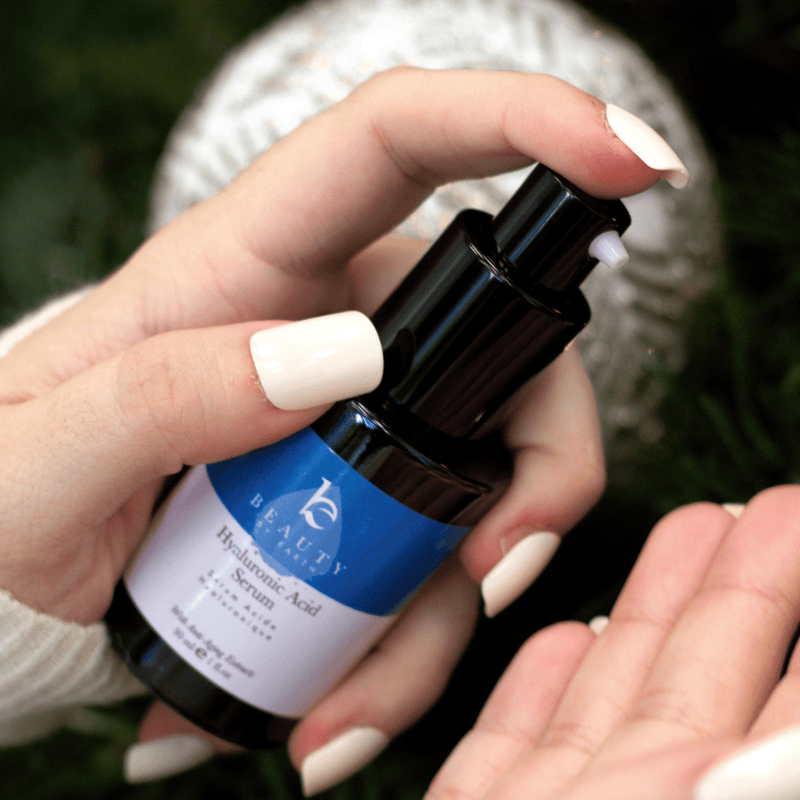 Hand holding a skincare serum bottle with a blurred background