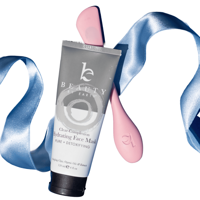 Tube of Beauty Earth face mask with pink applicator and blue ribbon on a white background