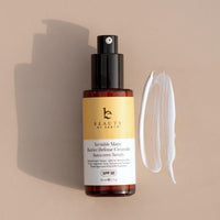 Sunscreen serum bottle with a smear of product on a beige background