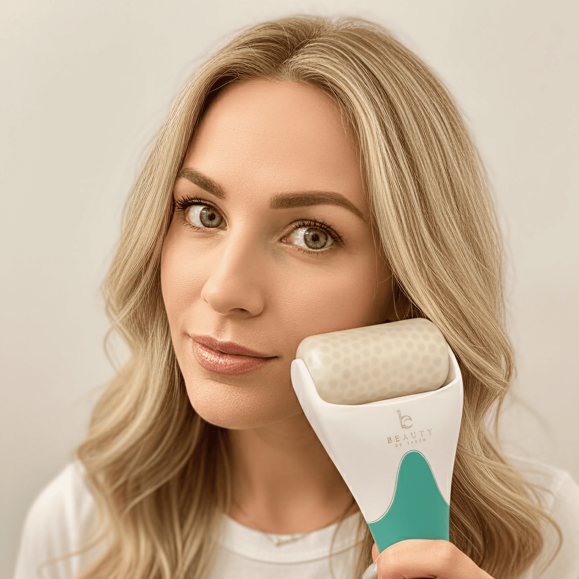Woman holding a skin care ice roller device with a visible brand logo.