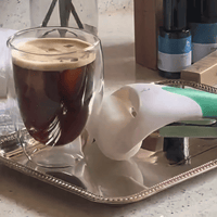 Glass of coffee on a tray with ice roller 
