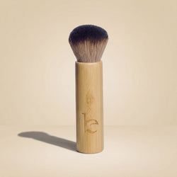 Kabuki facial brush on a beige background