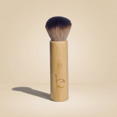 Kabuki facial brush on a beige background