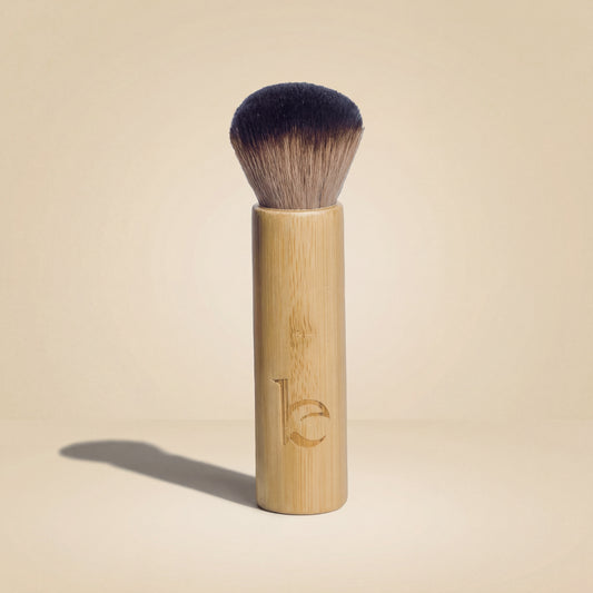Kabuki facial brush on a beige background
