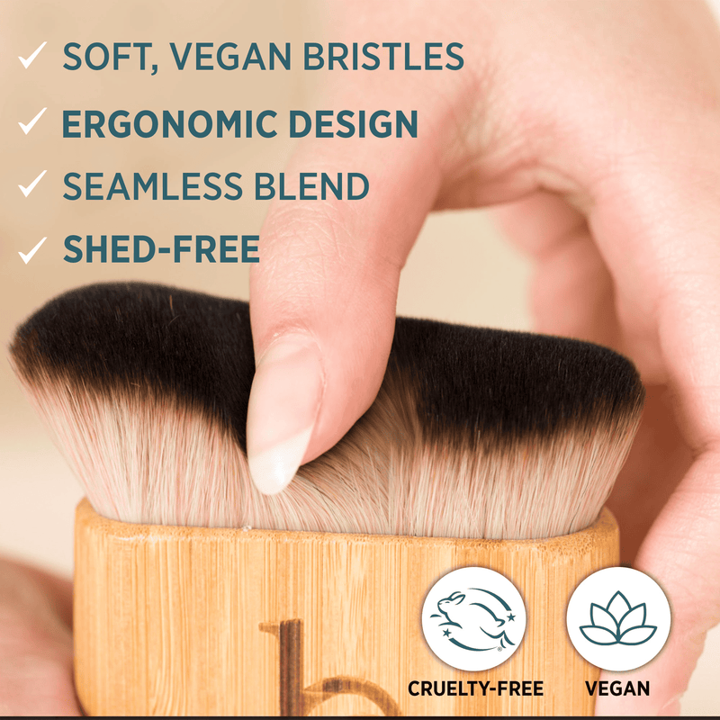 Wooden makeup brush with soft, vegan bristles held by a hand, featuring text and icons about product features.