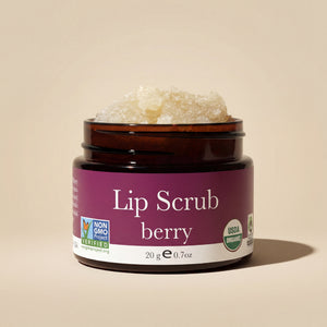 Jar of berry lip scrub with visible brand logos on a beige background