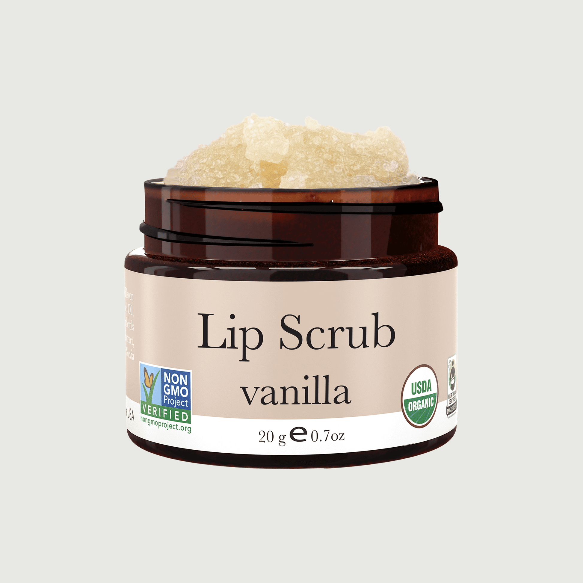 Jar of vanilla lip scrub with a beige background