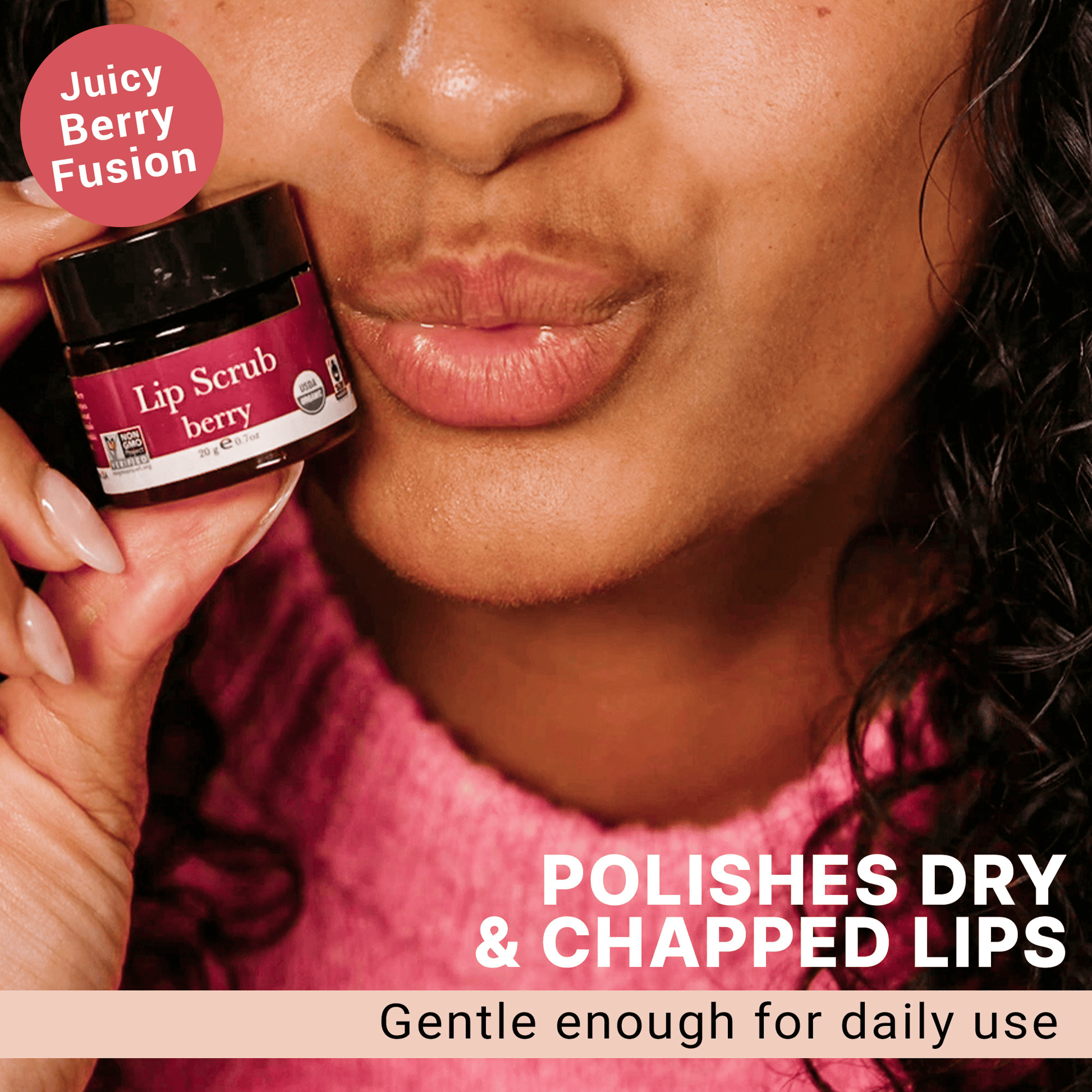 Person holding a lip scrub jar with text about its benefits