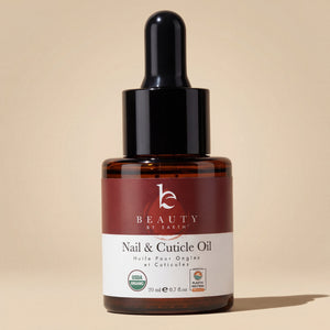 Bottle of Beauty by Earth Nail & Cuticle Oil on a beige background