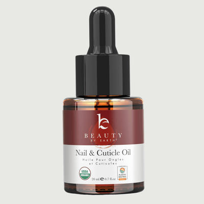Bottle of Beauty by Earth nail and cuticle oil on a light gray background