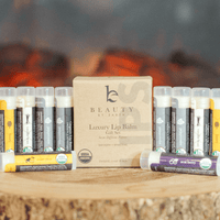 Lip balm set with a wooden box labeled 'Beauty by Earth' in front of a fireplace.