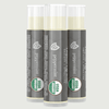Three tubes of peppermint lip balm with USDA Organic labels on a light gray background