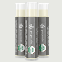 Three tubes of peppermint lip balm with USDA Organic labels on a light gray background