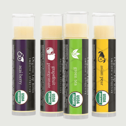 Four organic lip balm tubes with different flavors on a white background