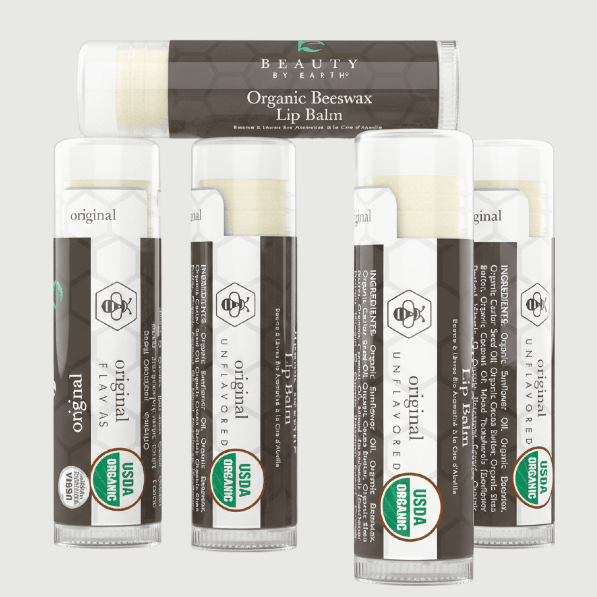 Set of organic beeswax lip balms with visible branding on a light gray background