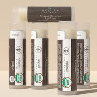 Collection of Organic Beeswax Lip Balms by Beauty by Earth on a beige background