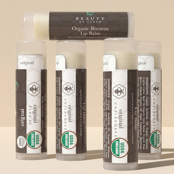Collection of Organic Beeswax Lip Balms by Beauty by Earth on a beige background
