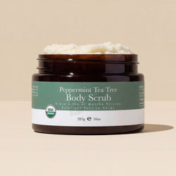 Peppermint Tea Tree Body Scrub jar with visible scrub on beige background