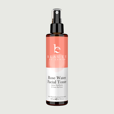 Rose Water Facial Toner bottle with pink label on a light gray background
