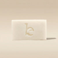 Shaving soap bar with a logo on a beige background