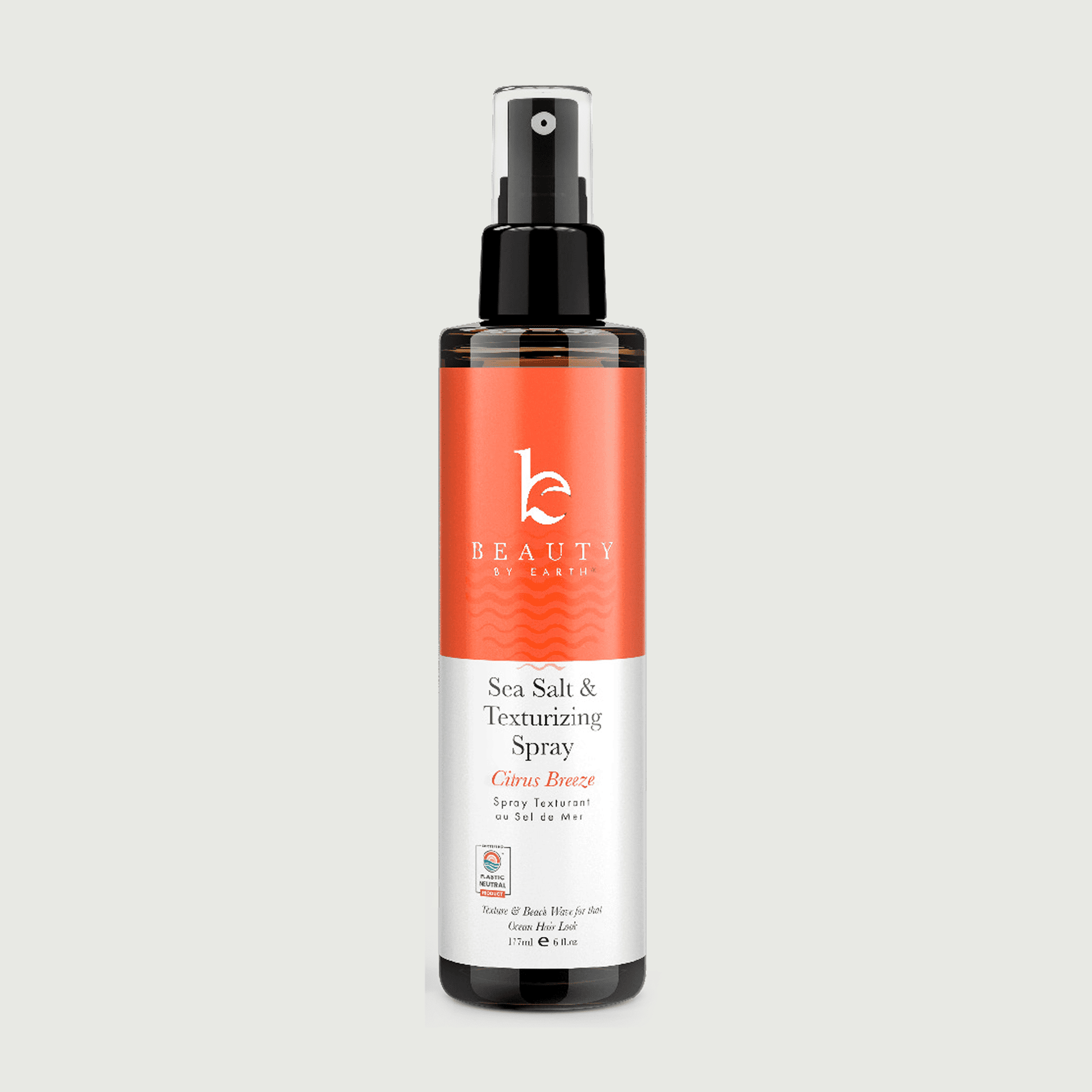 Sea Salt & Texturizing Spray bottle with orange label on a light gray background