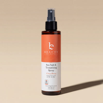 Sea Salt & Texturizing Spray bottle on a beige background