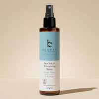 Sea Salt Spray Hair Texturizer bottle for natural volume and texture, vegan formula, on beige backdrop