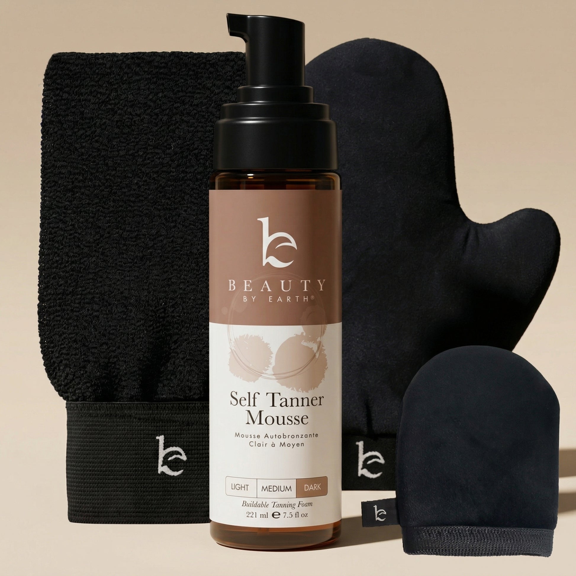 Self Tanner Mousse with applicator mitts on a beige background