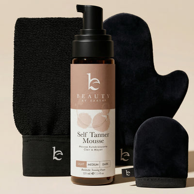 Beauty by Earth self Tanner mousse with applicator mitts on a beige bg background