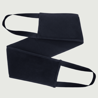 Black back applicator with a strap on a light gray background