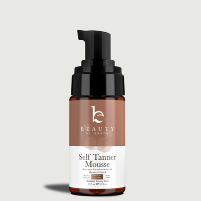 Bottle of Beauty by Earth self Tanner mousse on a light gray background