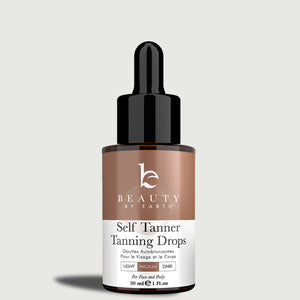 Beauty by Earth self Tanner tanning drops bottle on a light gray background