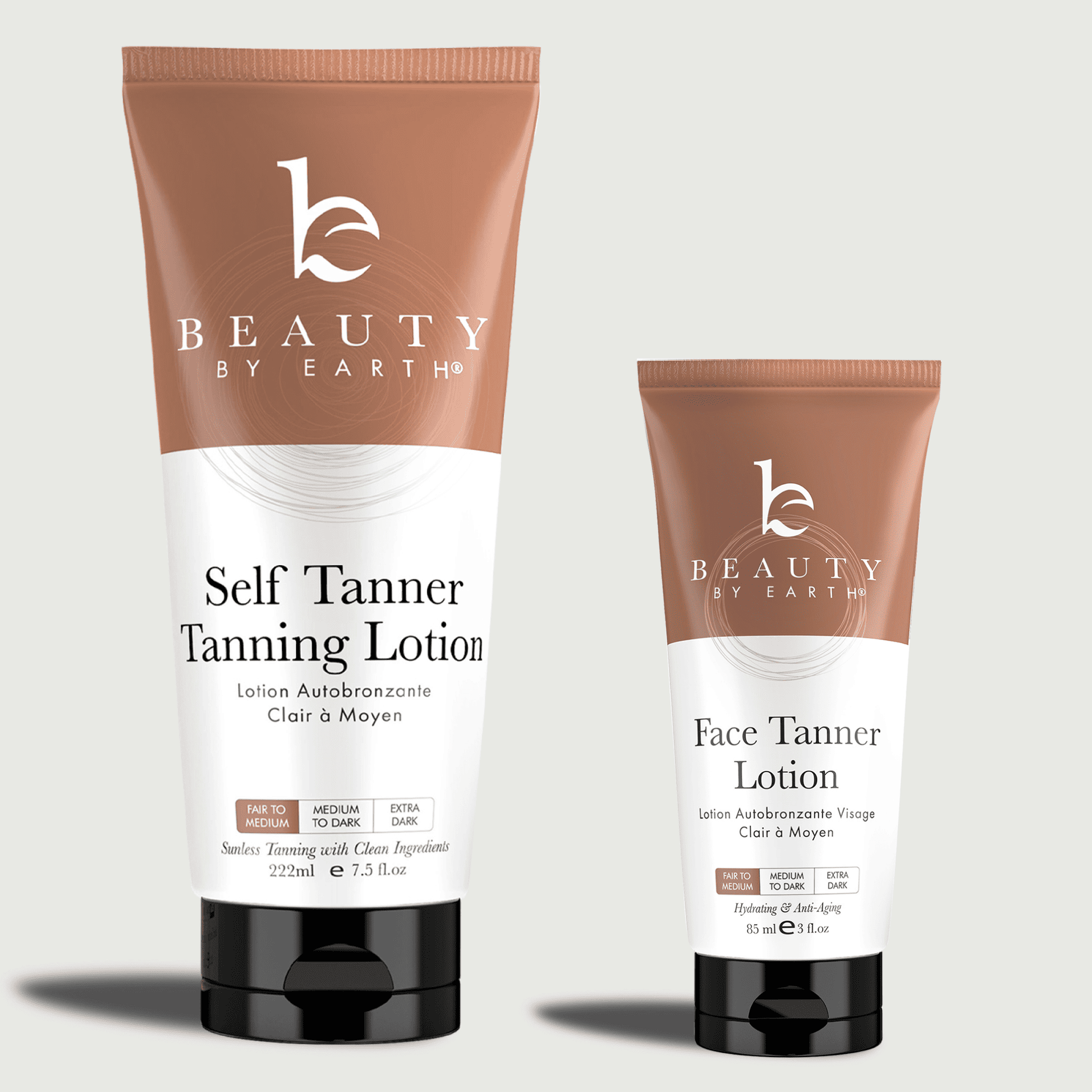 Two tubes of 'Beauty by Earth' tanning lotion, one of a self tanner tanning lotion and one of the face tanner lotion on a light gray background