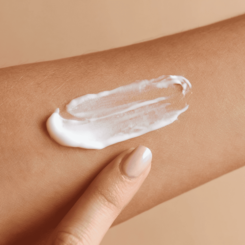 Self tanning body lotion texture white on model arm