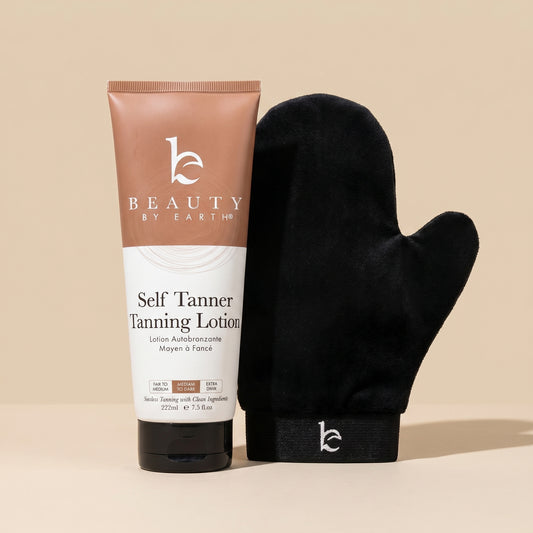 Tube of Beauty by Earth self Tanner tanning lotion with a black mitt on a beige background