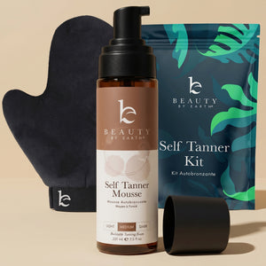 Beauty by Earth self Tanner mousse, mitt, and packaging on a beige background