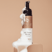 Beauty by Earth Self Tanner Mousse bottle with foam on a beige background