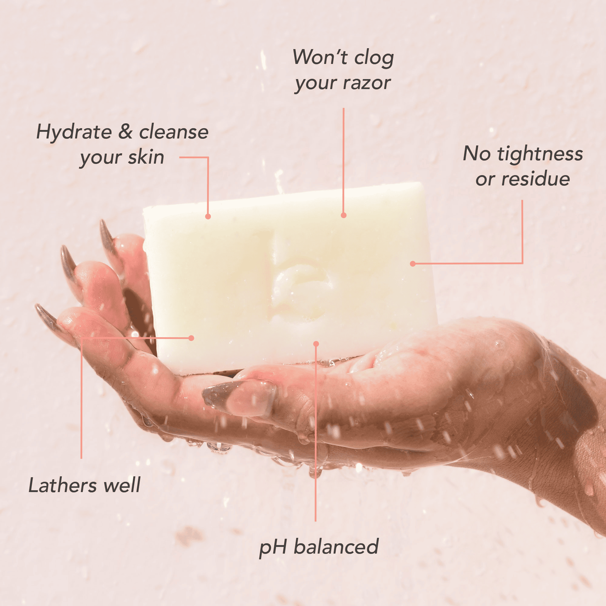 Hand holding a bar of soap with text highlighting its benefits on a light pink background