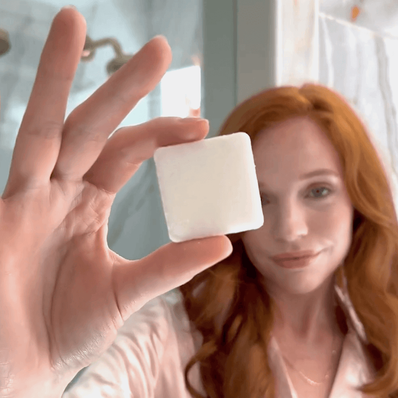 Shower steamer cube in hand before using it.