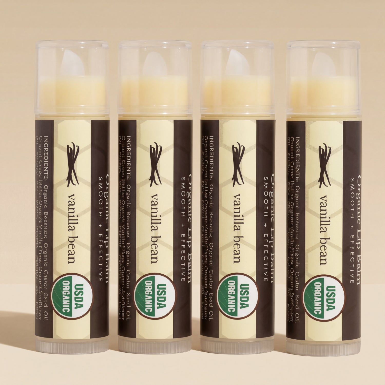 Four lip balm tubes labeled 'Vanilla Bean' with USDA Organic logo on a beige background