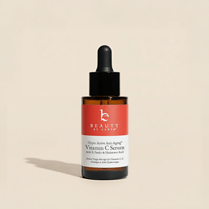 Beauty by Earth Vitamin C Serum bottle on a beige background