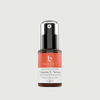 Vitamin C serum bottle with a red label on a light gray background