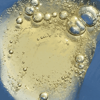 Close-up of a clear liquid with bubbles on a blue background