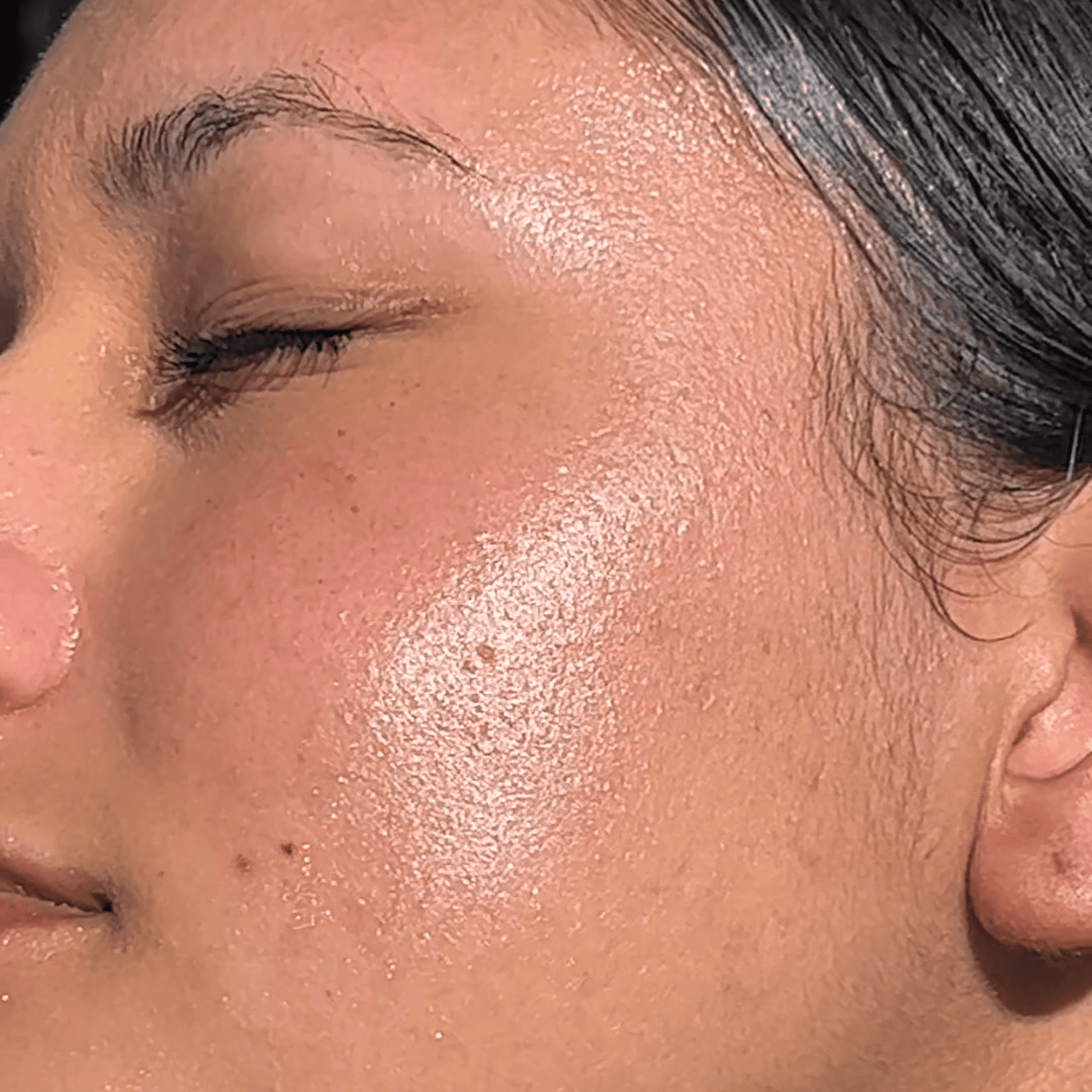 Close-up of a person's face with sun-kissed skin