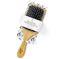 Boar bristle paddle hair brush with packaging on a white background