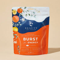 Packaging of Beauty by Earth Citrus Shower Steamers Burst for Energy on a beige background