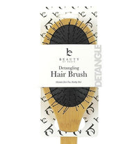 Detangling hair brush packaging with 'Beauty by Earth' branding on a white background