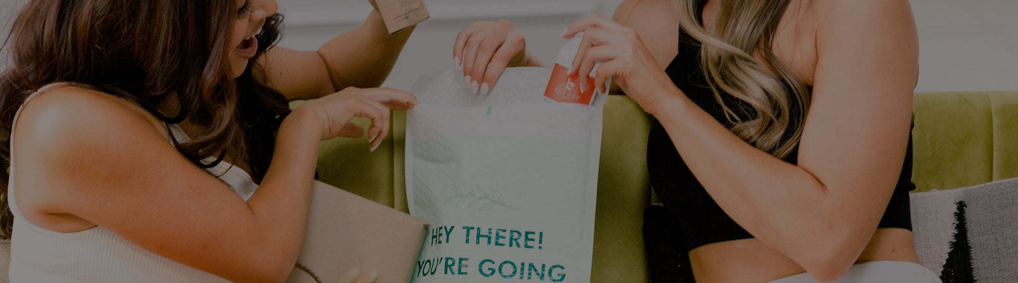 Two women sitting on a couch with Beauty by Earth Products