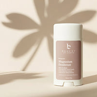 Deodorant stick with 'Beauty by Earth' branding on a beige background